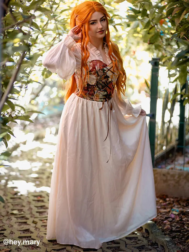 Woman wearing NSPSTT romantic floral jacquard puff sleeve maxi dress with flowing skirt in natural sunlight